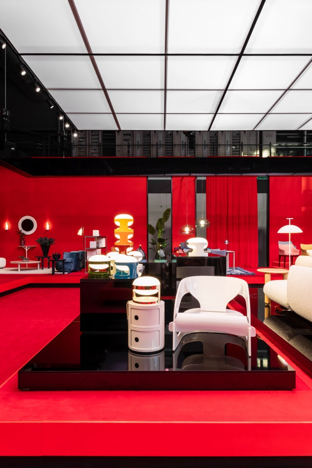 The Kartell stand at the Salone del Mobile 2025 featuring classics including Joe Columbo's KD28 and Fauteuil chair, and the Componibili by Anna Castelli Ferrieri. Photo c/o Kartell.
