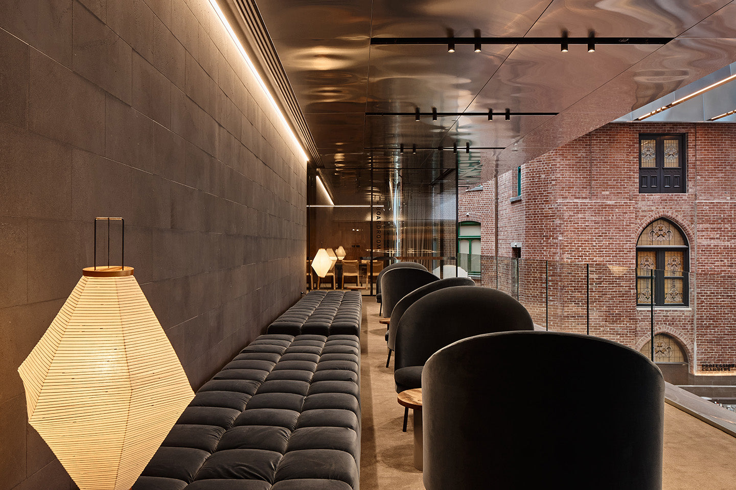 View of an anti-space with B&B Italia Tufty-Time and Jim armchairs by Arflex towards the boardroom, offset by the warmth of the surrounding heritage buildings. Photography © Peter Bennetts c/o Hassell.
