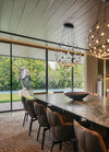 The formal dining room with framed views to the garden. Husk dining chairs by Patricia Urquiola for B&B Italia.
